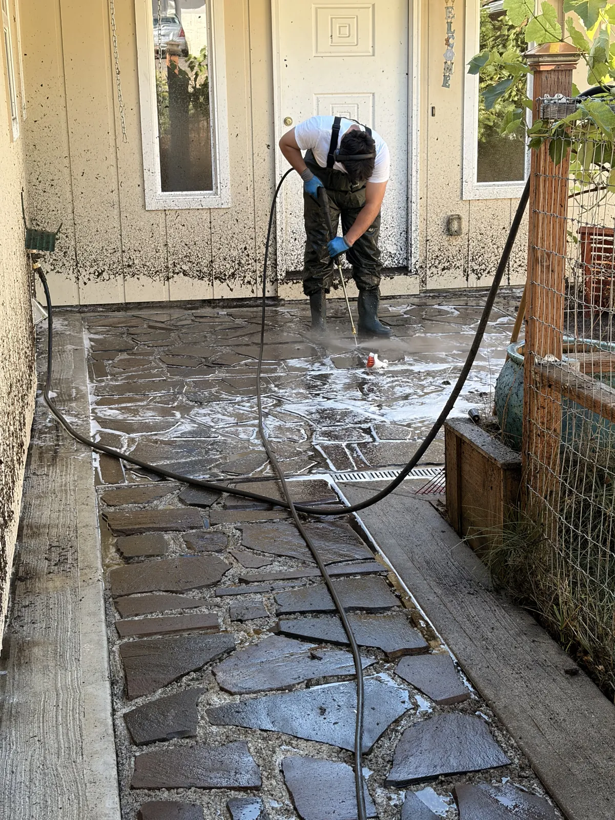 Strickland Pressure Washing scrubbing a flagstone patio